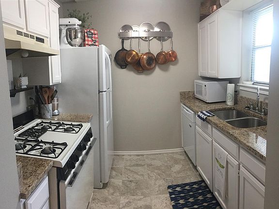 Updated kitchen with granite counters and tile flooring.