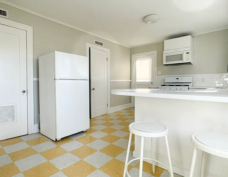 Large kitchen with modern appliances, dishwasher, and garbage disposal.