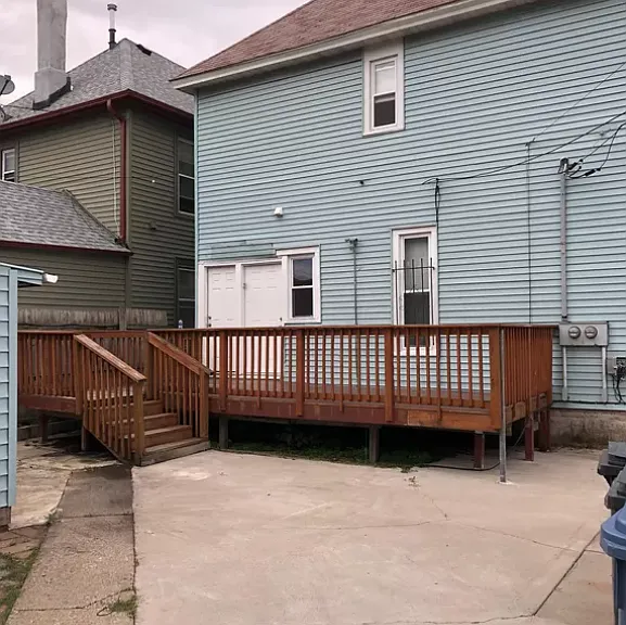 Shared deck space, back entrances, parking slab (for unit 2)