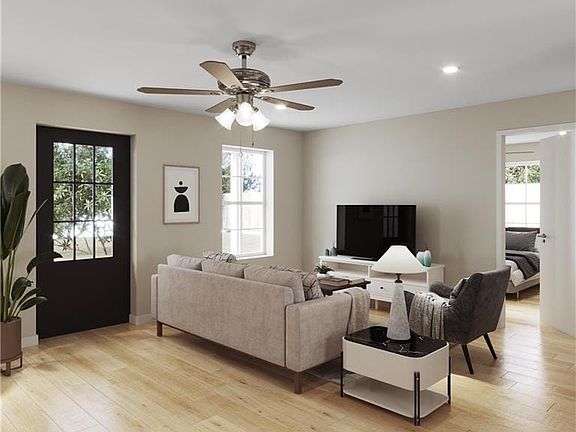 Living room rendering with plenty of natural light, light hardwood / wood-style floors, and ceiling fan
