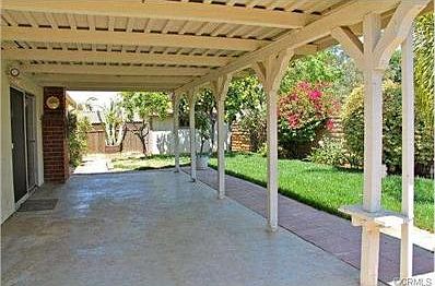 Terrific backyard with a covered patio, gorgeous lawn and a larg