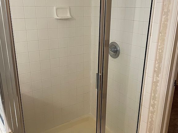 Walk in tile shower, in Master bathroom. The walk-in carpeted closet doorway shown. The master toilet doorway, is also off to the right, of this photo.