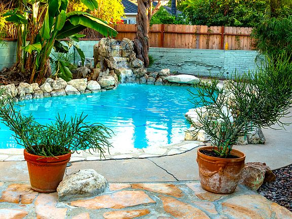 Pool has natural river rock functioning waterfall. Pool newly remodeled and re-plastered. New flagstone patio.