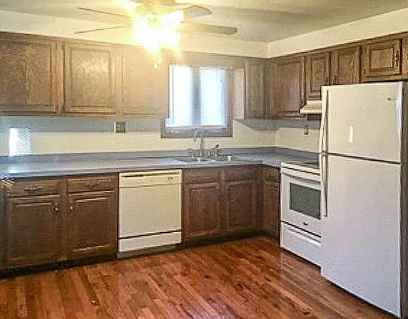 Beautiful kitchen with oak cabinets, hardwood floors, ceiling light/fan, all new Whirlpool appliances.
