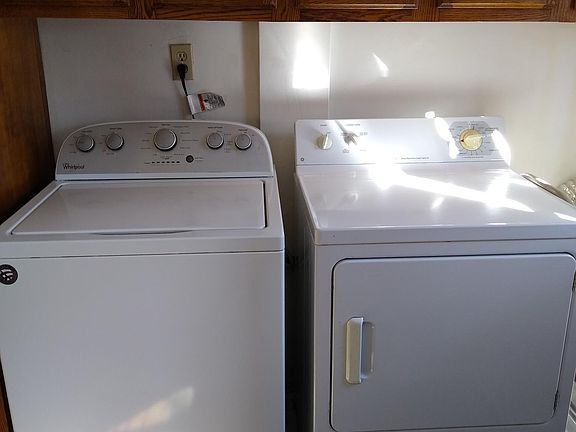 Washer and dryer in the kitchen. Door to rear yard is to the right.