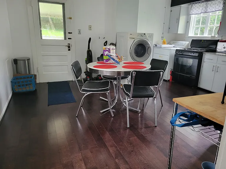 BIG Eat in Kitchen. Sunny. New Sept '24 gas stove. Windows. Washer and Dryer. French Fridge. Granite counters. 1920 Barn Find Farm Sink.. Dark Hardwoods. Leads to covered patio overlooks big grassy back yard with mature trees. Fenced patio-small yard.
