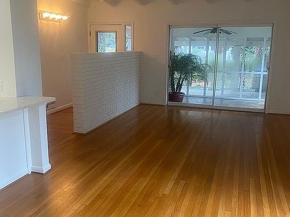 Living room area with sunroom off the side.