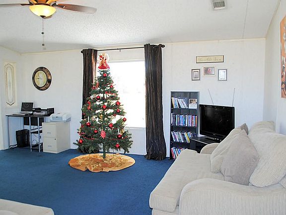 Living room has vaulted ceiling & view of backyard