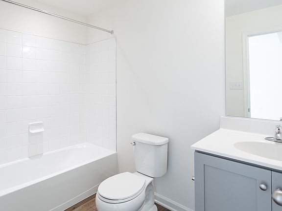 Finished lower level full bath with gray vanity cabinets in a DRB Homes York II Garage Plan in the
