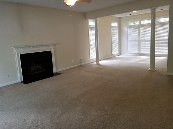 Living Room with fireplace and dining room in the background