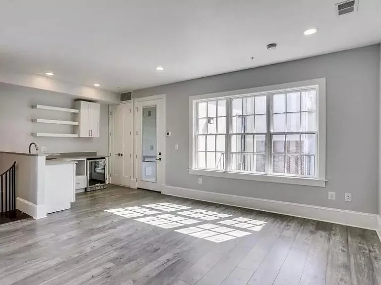 upstairs kitchenette and living area with balcony on other side of windows