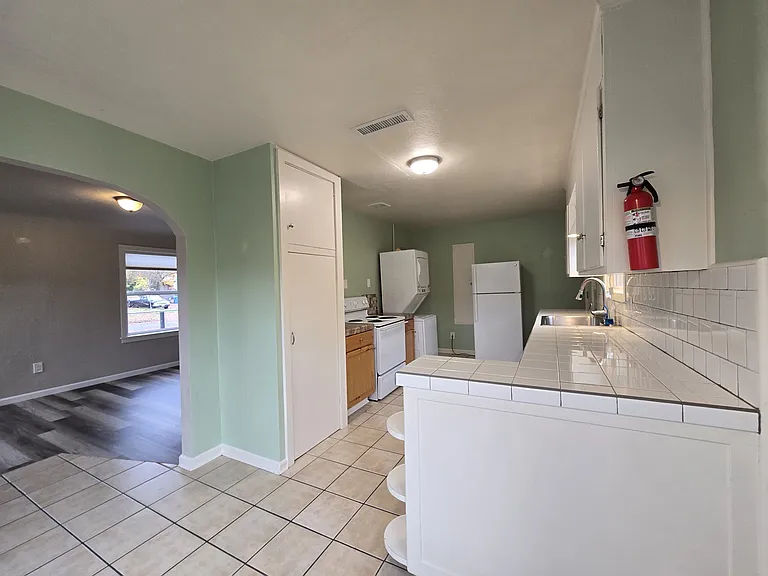 Spacious kitchen, ample cabinetry storage, full size refrigerator.