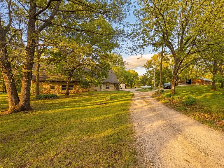 Private, tree-lined drive with massive parking space.