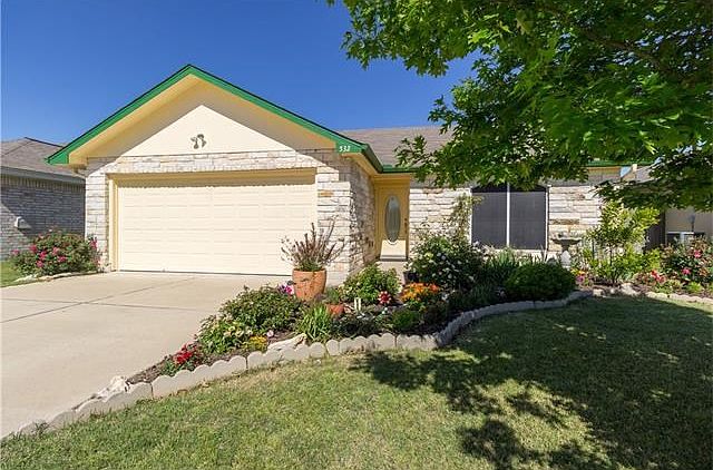 Beautiful landscaping surrounds this charming home.