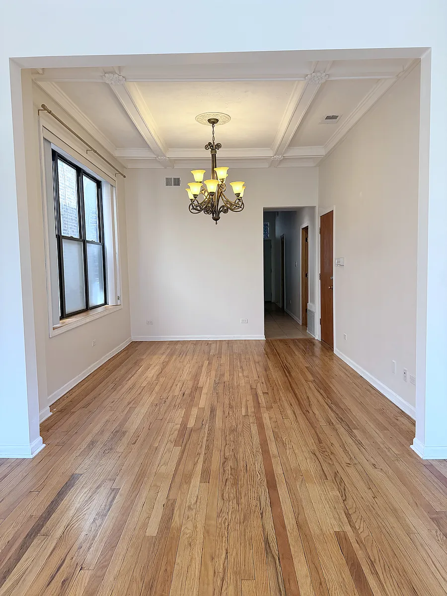 Dining Room
Formal dining room with original coffered ceilings, ornate molding, and a chandelier that's been part of this building since day one. - 1737 N Damen Ave #2