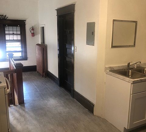 The common space, kitchen area.