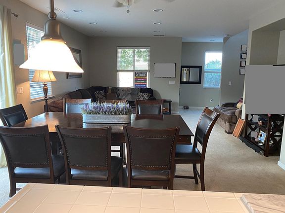 View from kitchen: The kitchen overlooks the dining and living room. There is a coat closet, powder room, and laundry room on the first level.