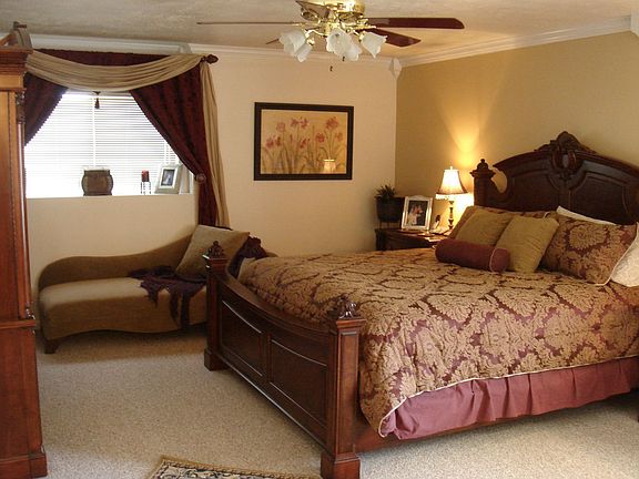 Extra large master bedroom with french doors, walk in closet, and custom moldings (base, door, window, and crown moldings).