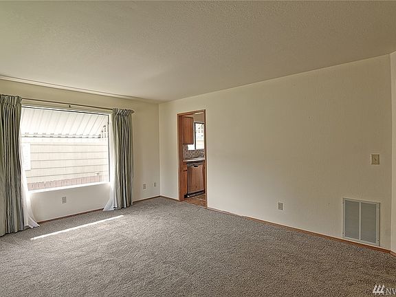 The light and bright living room opens to the oversized kitchen.  The doorway to the right leads to the hall between the two upstairs bedrooms and the full bathroom.