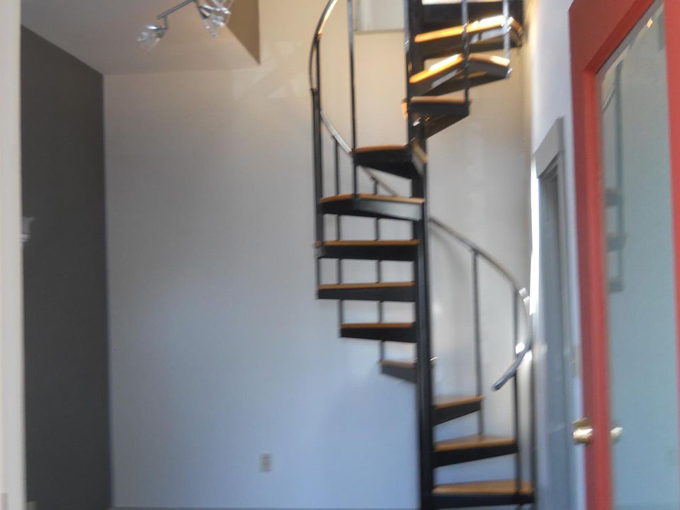 Enter back door into the Den which leads into the Hallway and the Spiral Staircase up to 2nd. floor bedroom.