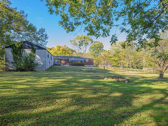 viewing garage & south face 335 Dade Dr from fenced in backyard
