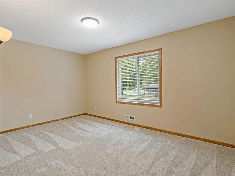 Primary bedroom with two large closets, new carpet, and fresh paint