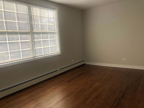 Living room with hardwood floors and coat closet