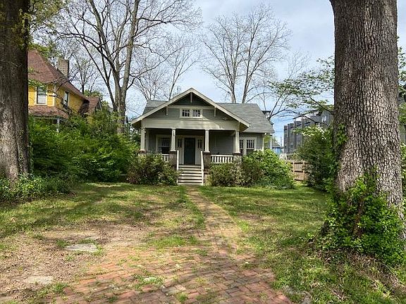 Huge front yard with a parking pad. Pull in driveway with 3 spots in the back as well.