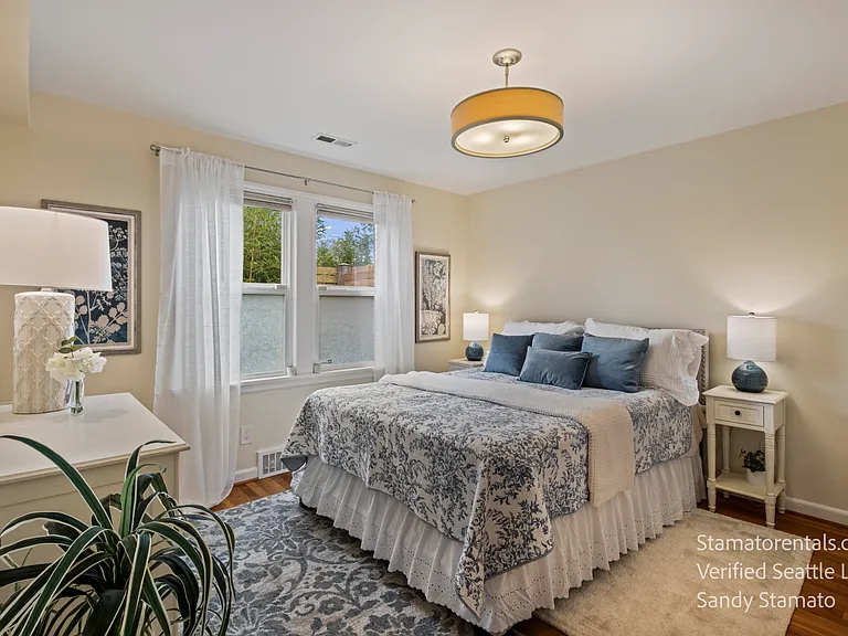 Peaceful second bedroom with lush bamboo just outside the window, beautiful natural light, and a premium queen Saatva Latex Hybrid mattress.