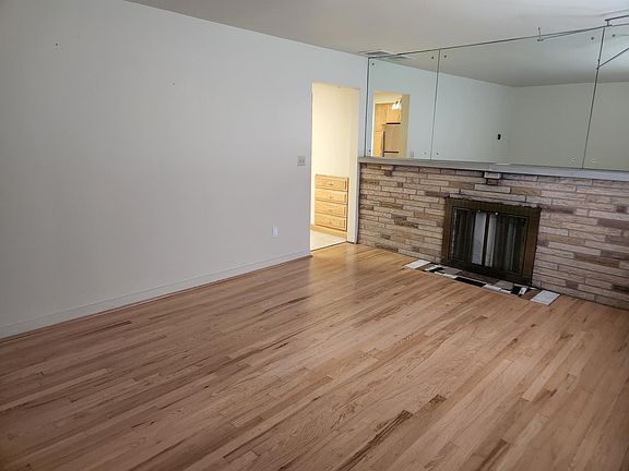 Recently refinished hardwood floors in dining room/living room space