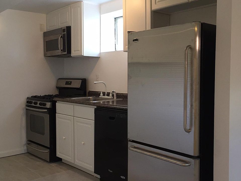 stainless steel kitchen equipped with refrigerator, dishwasher, oven, stove, built-in microwave, and plenty of cabinet space