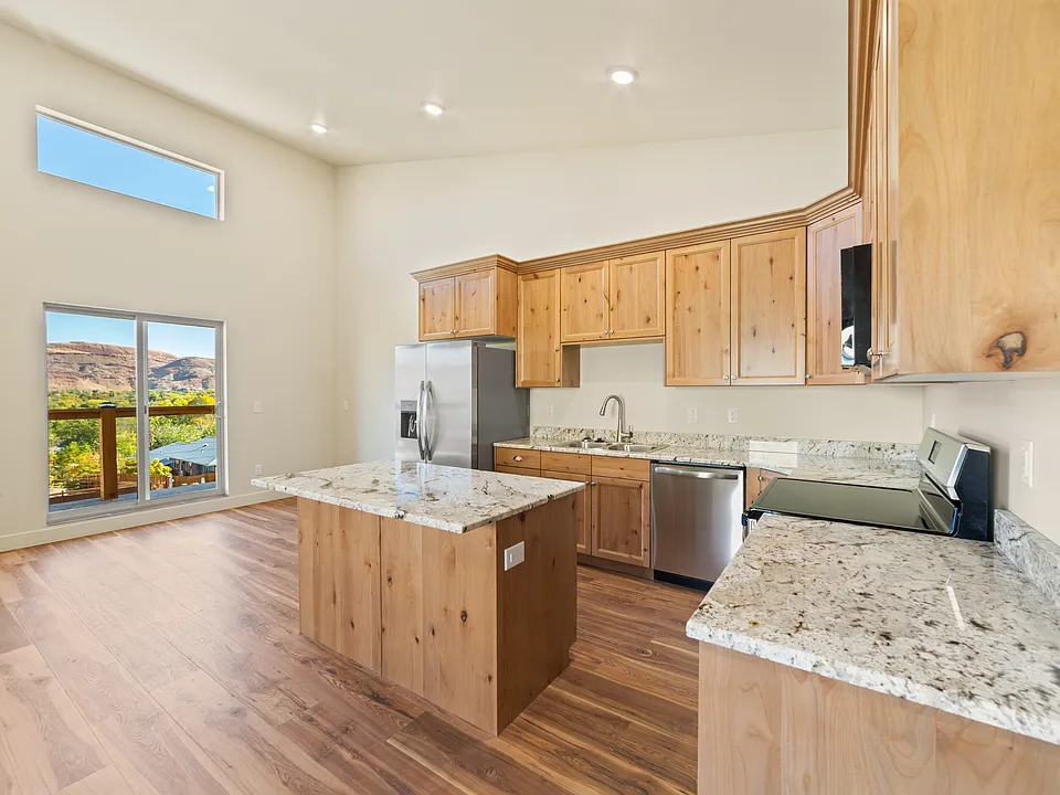 High ceiling kitchen and living room area. Quality custom cabinets and stone countertops. All appliances brand new. Fridge, dishwasher, stove, microwave.