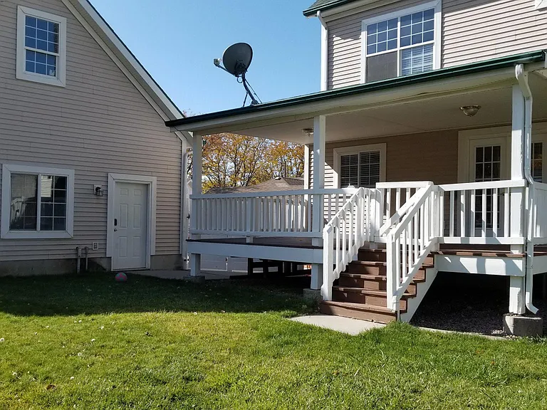 Backyard, shows back deck and garage.