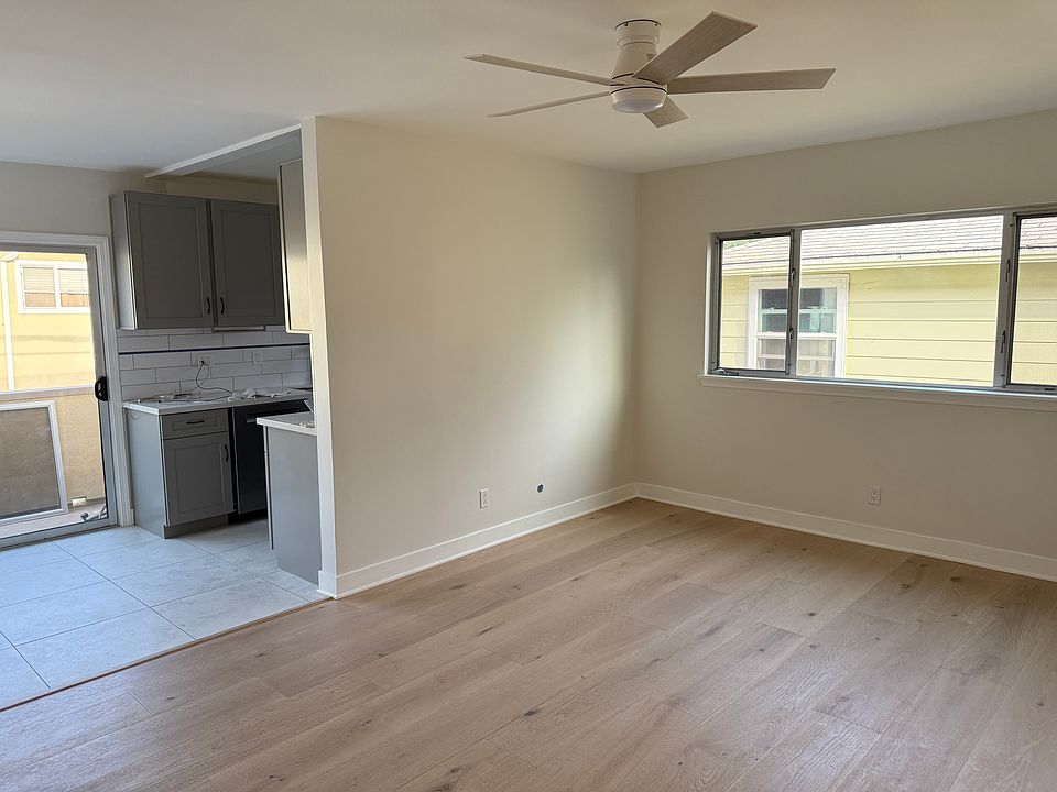 Living room with peek of kitchen and patio