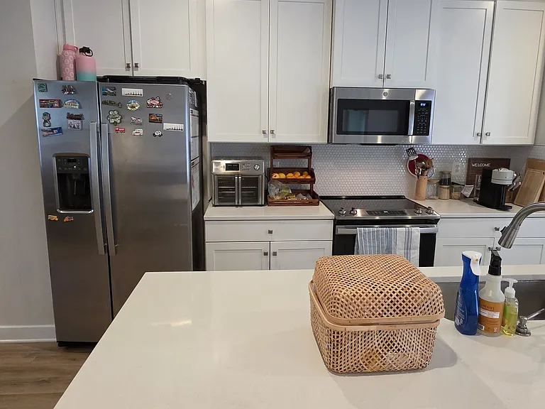 Kitchen; view from island towards the cabinet and stove area.