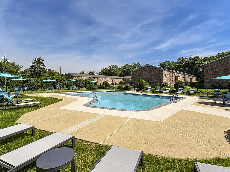 Outdoor pool with umbrellas and lounge chairs