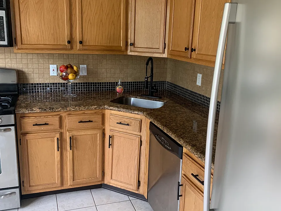 Large kitchen with corner sink. Ample storage above and below. New refrigerator. Can add small kitchen table in addition to dining room. Recessed lighting. All appliances.