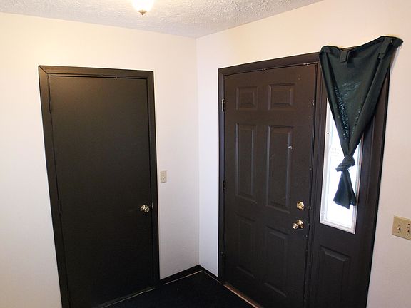 Foyer facing front door and garage on left