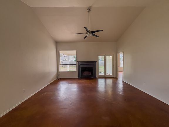 Living room with bright windows overlooking backyard and fireplace for cozy nights