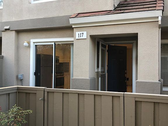 This townhome is located by a lovely grassy area with mature trees and well-landscaped garden.