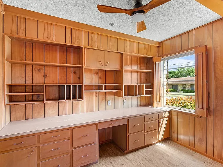 Office with lots of cabinets, extensive countertop and nook for desk chair; Room for Filing cabinets/Love seat or Recliner on opposite wall.