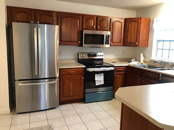 Kitchen with matching appliances. Fridge contains ice maker and filtered water on inside of door.