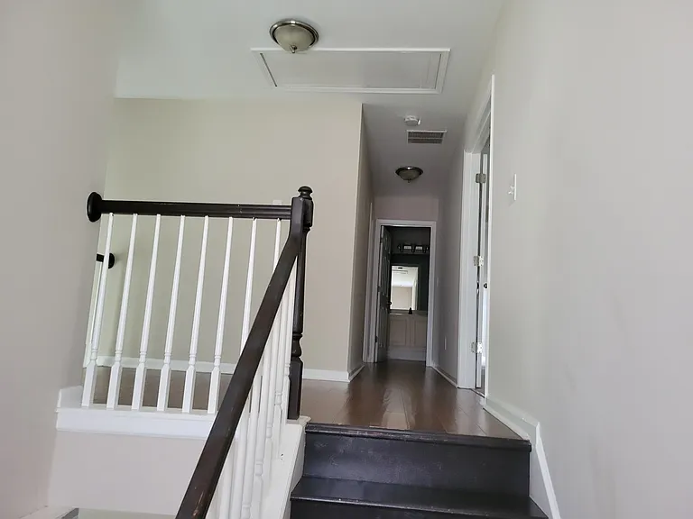 Picture going up the stairs. At the end of the hallway is a full bath. To the right is the Master. To the immediate left is a bedroom. Half way down the hall way and before the bathroom is another bedroom.