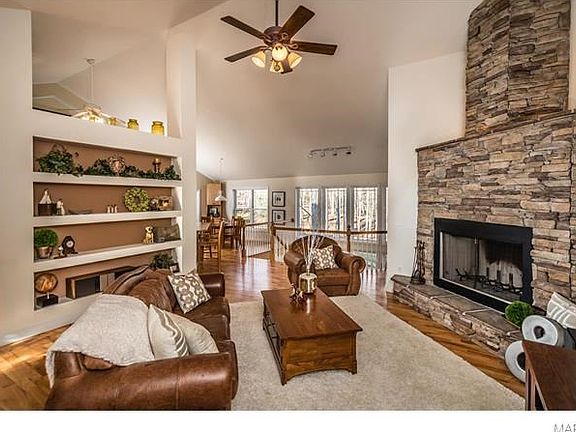 Beautiful stone-stacked fireplace and built-in bookcases