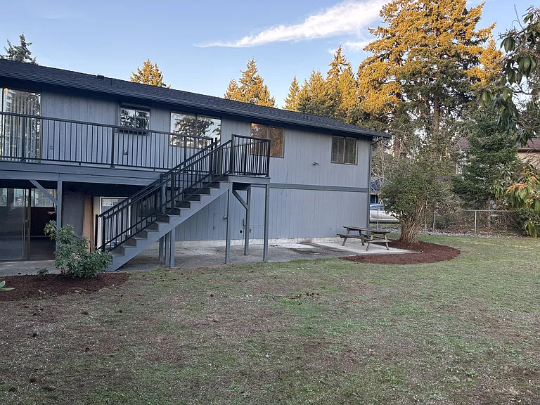 View of the spacious back yard, including the deck and large patio space