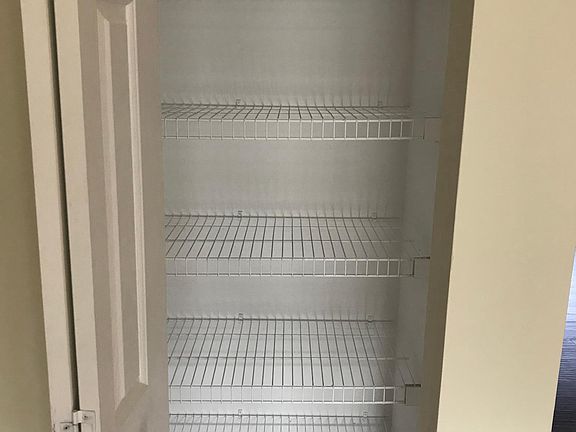 Pantry in kitchen with built-in shelving
