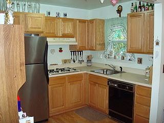 Newer cabinets and wood laminate flooring in Kitchen