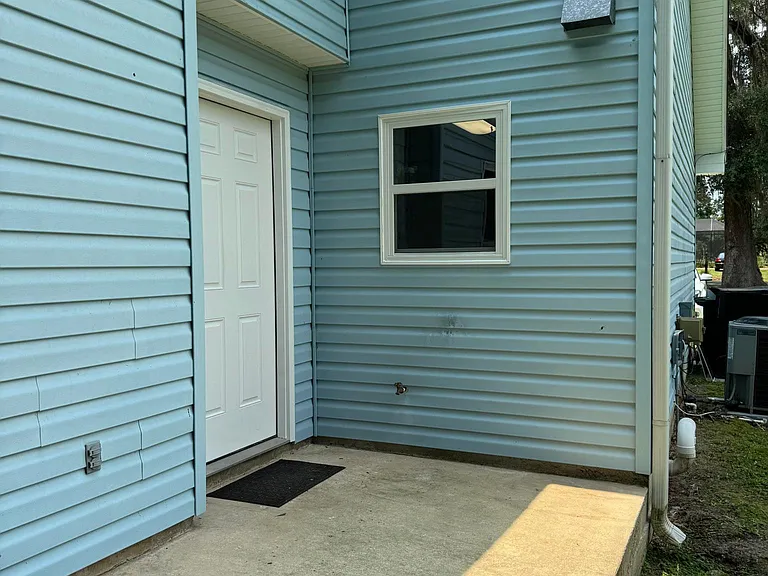 Backyard door and small patio
