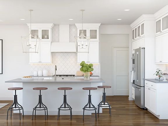 Kitchen with glass upper cabinets and pendant lighting