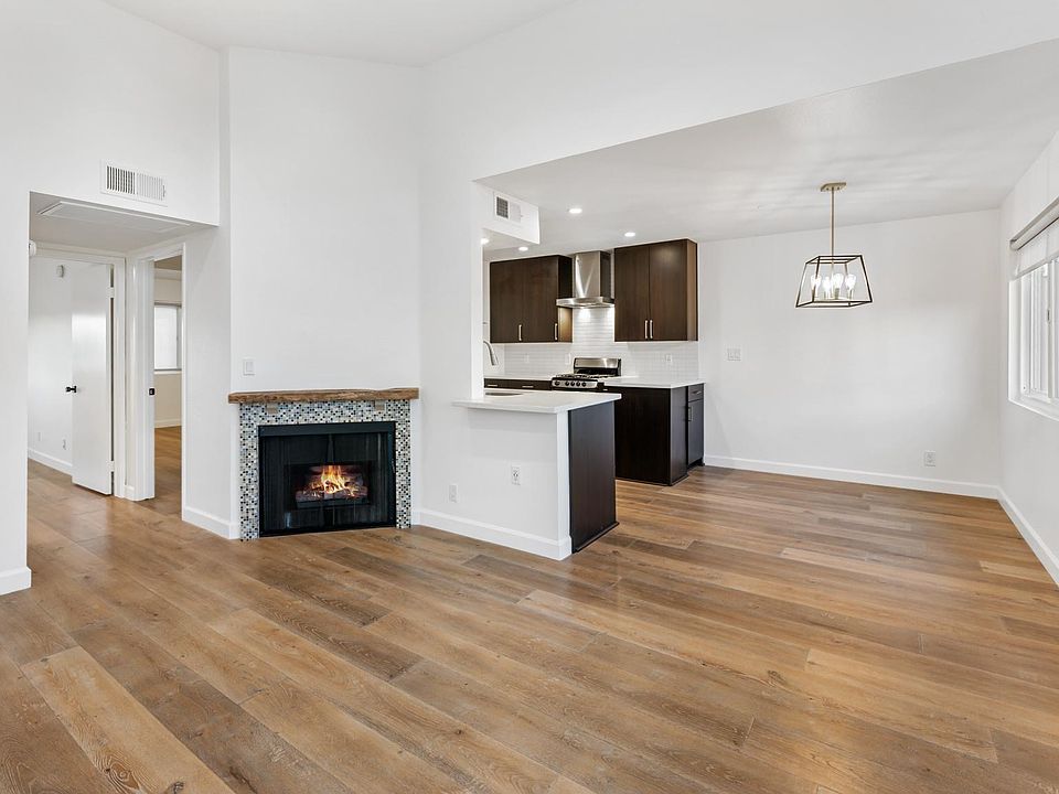 Top floor w/ high 12 foot+ ceilings in the great room open with the dining and custom kitchen. Designer dining pendant.